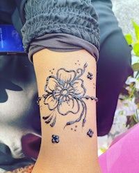 a woman with a flower tattoo on her wrist