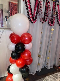 a red, white and black balloon decoration in a room