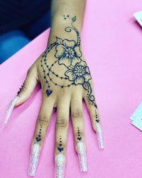 a woman's hand with henna on it