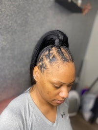 a woman with braided hair in a salon