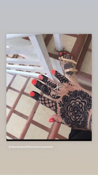 a woman's hand with henna on it