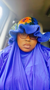 a woman wearing a blue hat in a car