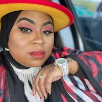 a woman wearing a hat and a watch in a car