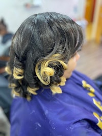 a woman is getting her hair done in a salon