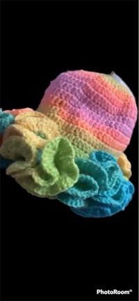 a colorful crocheted hat on a black background